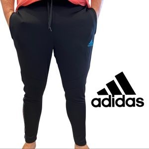 Adidas Tiro soccer pants, the brand with three stripes, various languages.